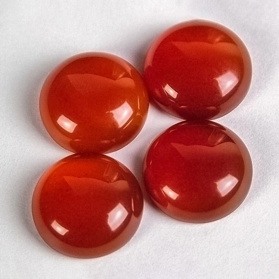 Four red-orange carnelian cabochons