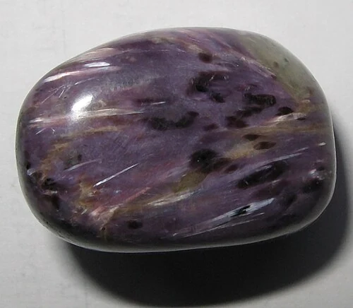 Purple polished charoite with pale streaks