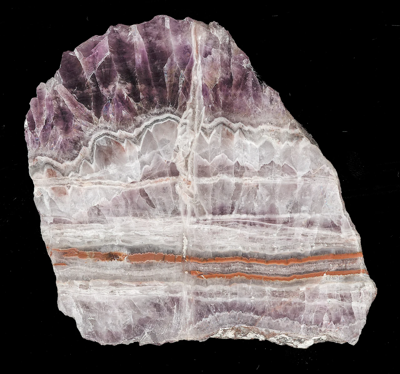 Cut and polished fluorite section from China with purple, white and thin reddish bands.
