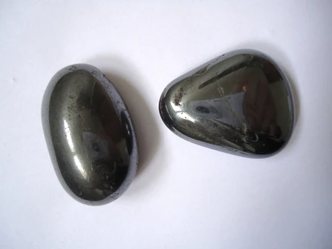 Two dark hematite pebbles with a pronounced metallic lustre.