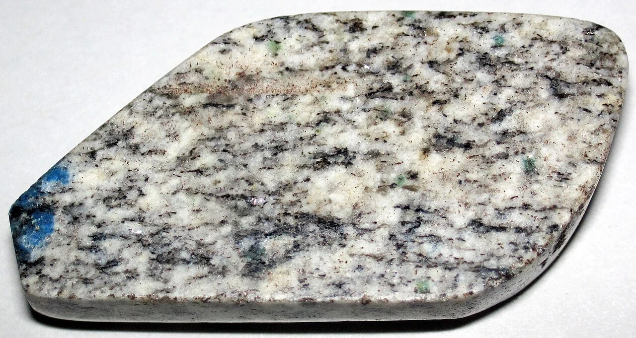 Polished K2 rock with an azurite spot near the edge