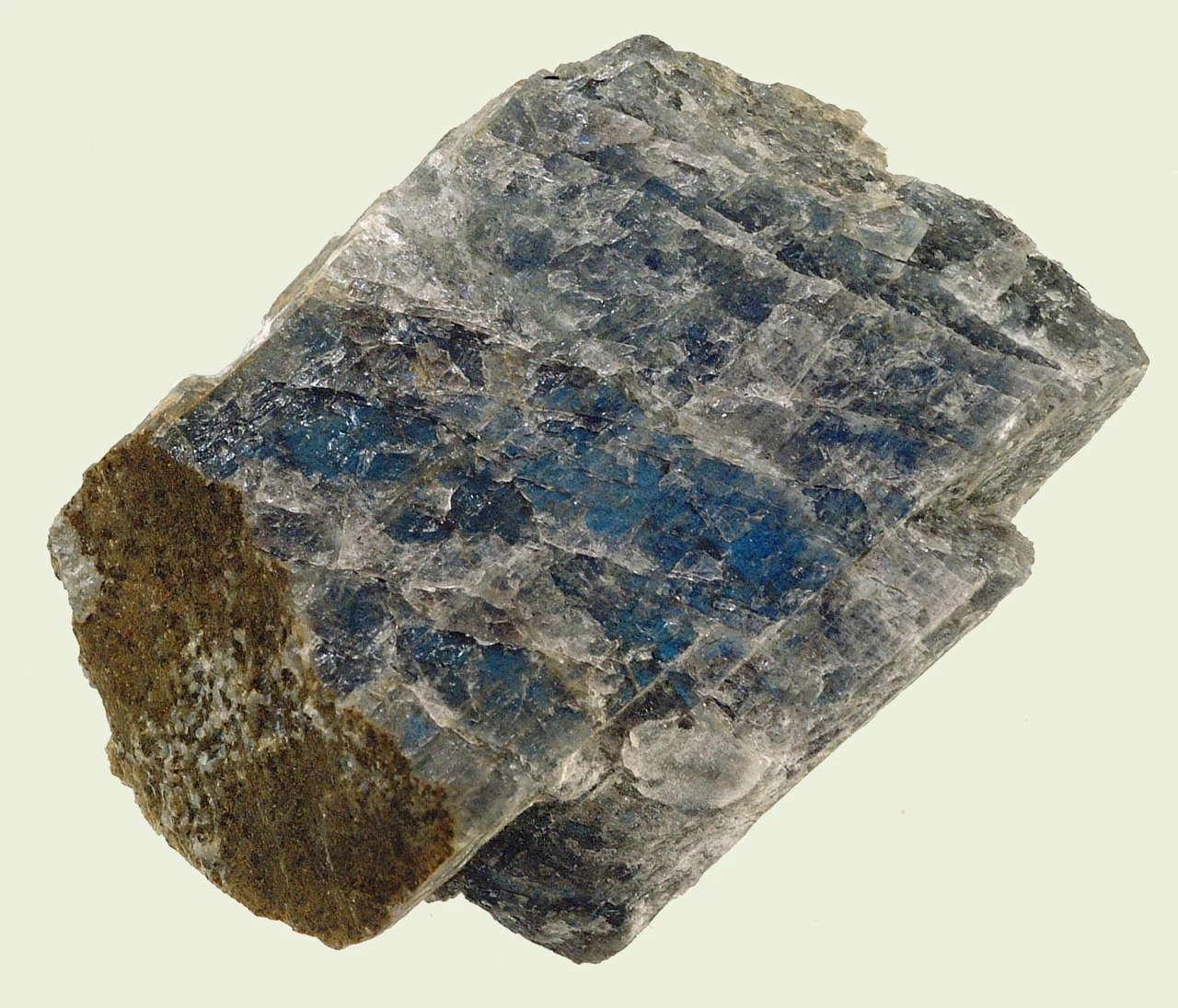 Angular labradorite specimen with a grey body and blue flashes.