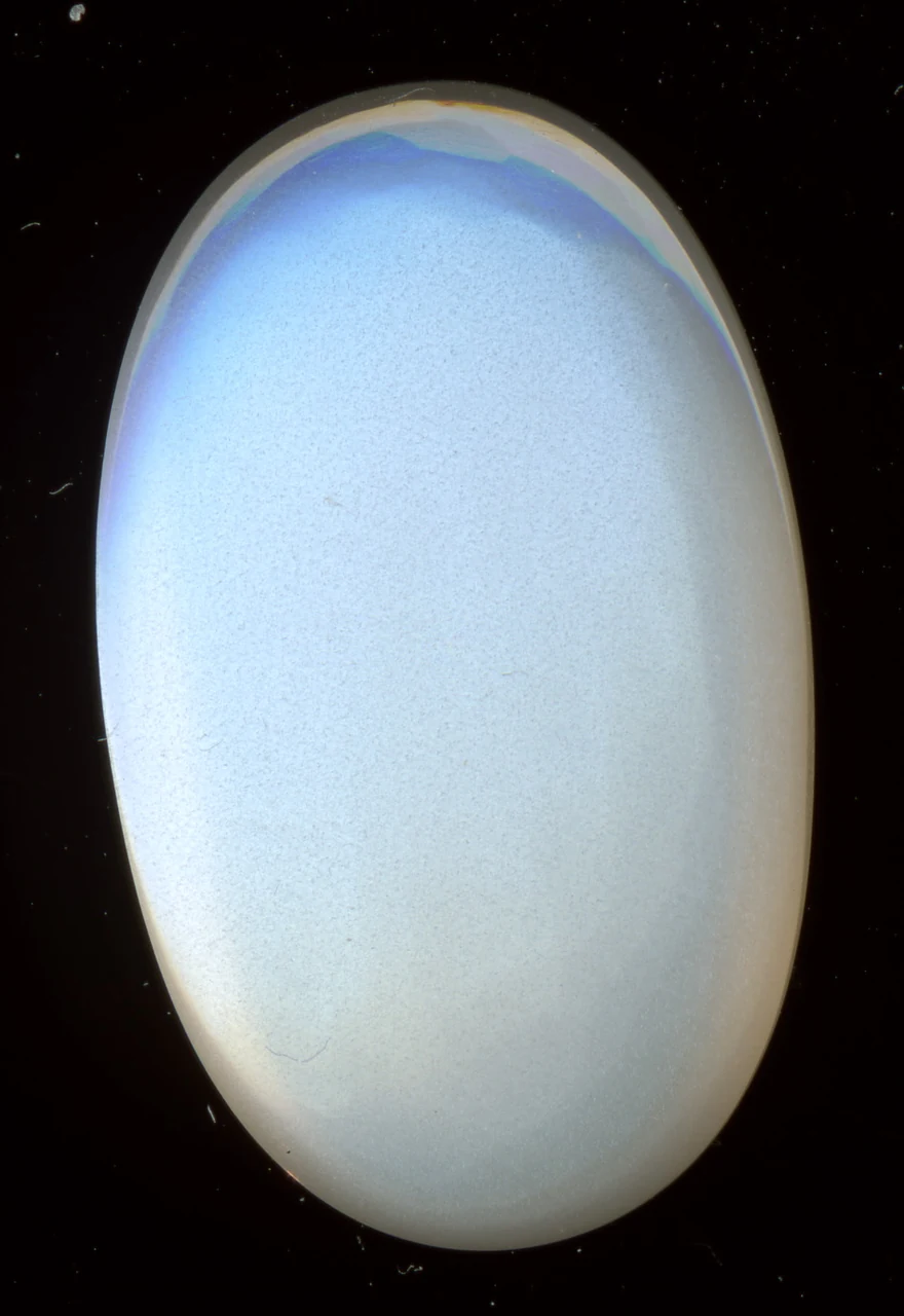 Oval moonstone cabochon with a soft bluish glow.