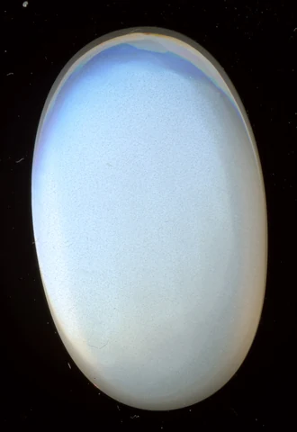 Oval moonstone cabochon with a soft bluish glow.
