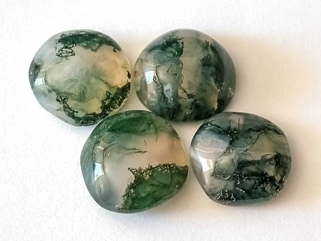 Four moss agate cabochons with green inclusions