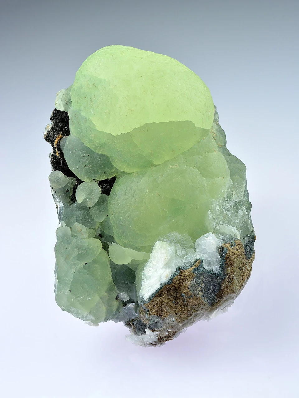 Pale green prehnite on darker matrix