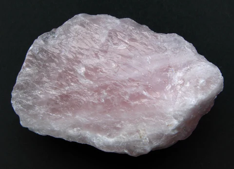 Rough pale pink quartz with an uneven, massive surface.