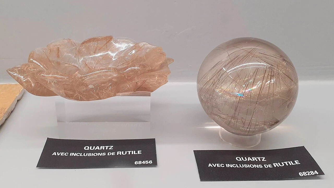 Rutilated quartz: a specimen and polished sphere on display