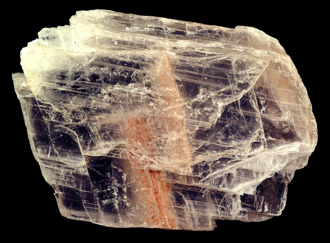 Transparent, layered selenite specimen — the clear variety of gypsum — about 8 cm across.