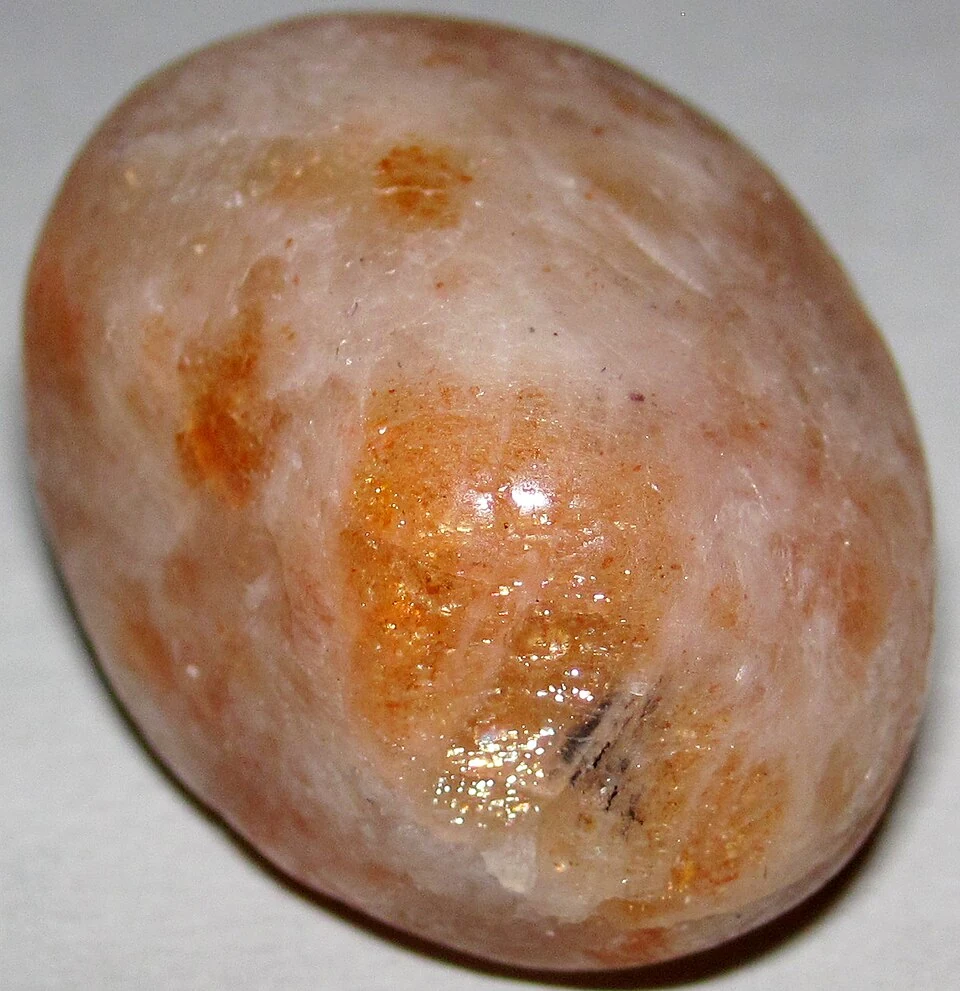 Pale tumbled sunstone with orange flecks